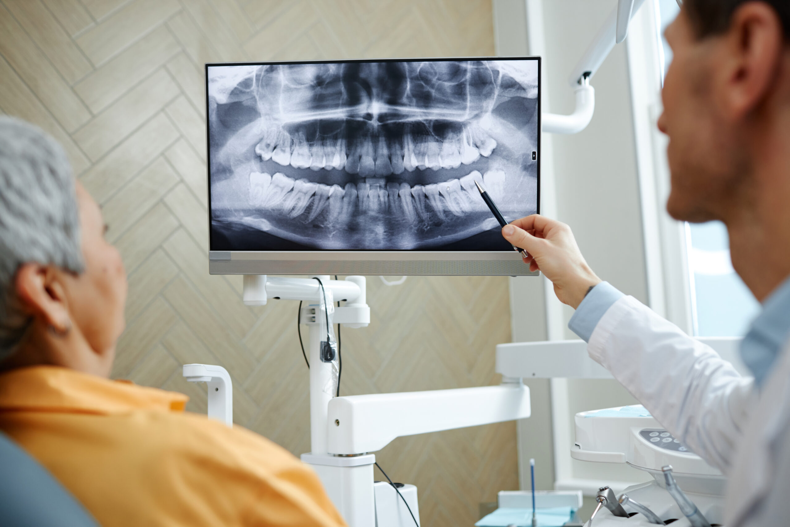 Dentists examining the oral side effects of chemotherapy and radiation therapy.